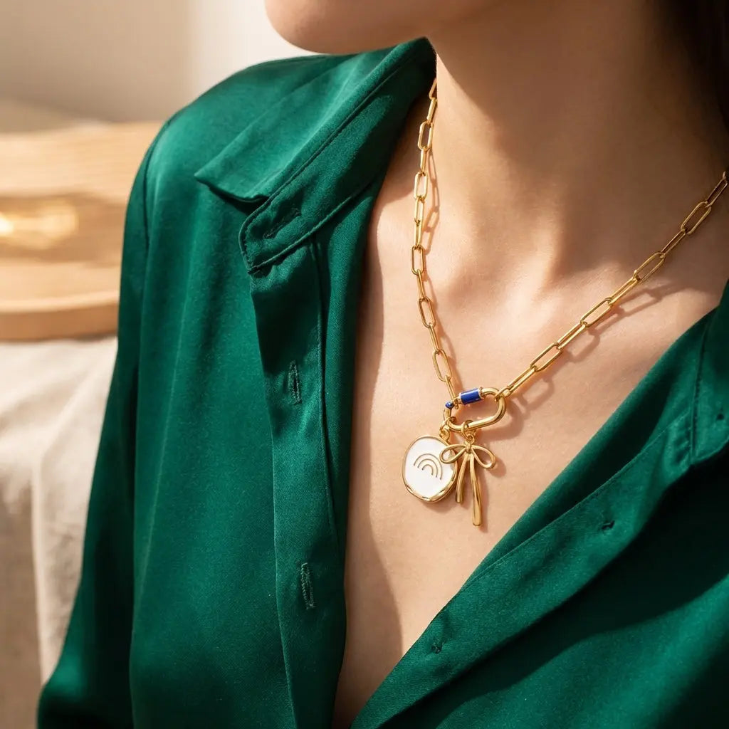Gold rainbow disc charm by Winks Design Studio LLC featuring a colorful rainbow design and a small loop for jewelry attachment.