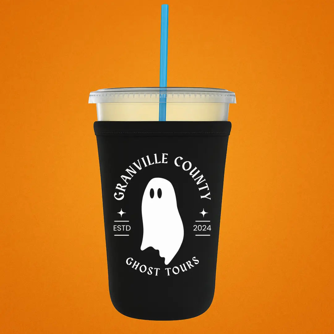 Winks Design Studio LLC Granville County Ghost Tours cup sleeve featuring spooky ghost illustrations on black background.