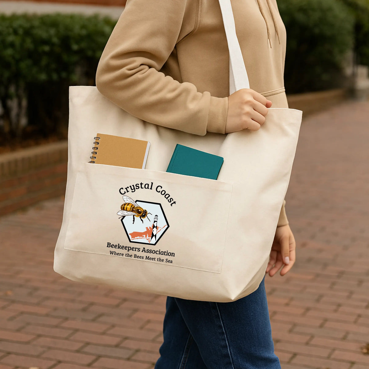 Winks Design Studio Crystal Coast Beekeepers tote bag with colorful bee and floral design on fabric, showing sturdy handles and spacious interior.