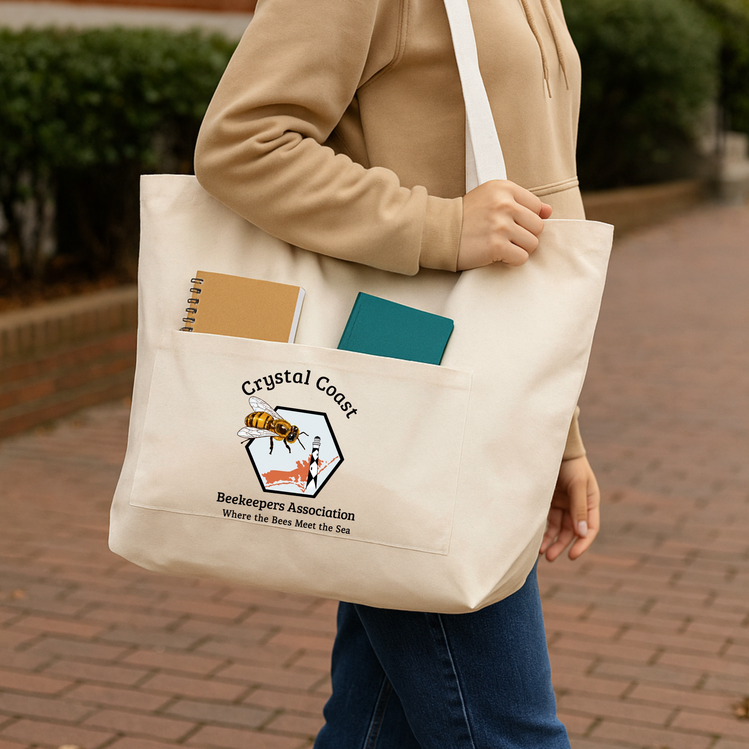 Winks Design Studio Crystal Coast Beekeepers tote bag with colorful bee and floral design on fabric, showing sturdy handles and spacious interior.