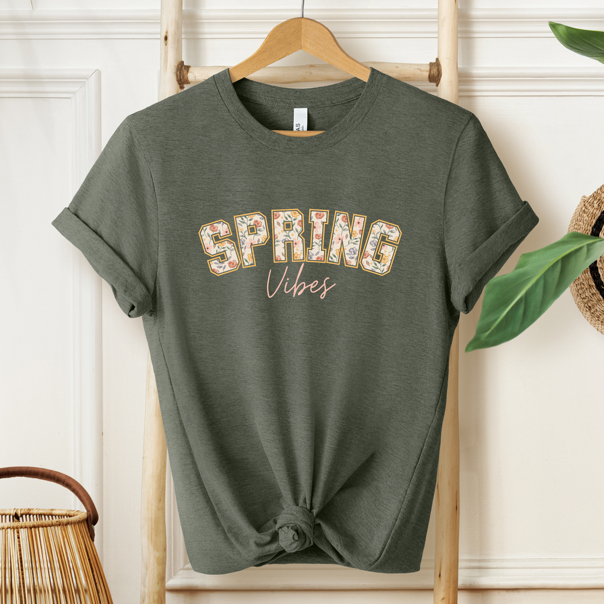 Winks Design Studio floral spring tee, lightweight cotton shirt with vibrant pastel floral pattern, casual and stylish for warm weather.