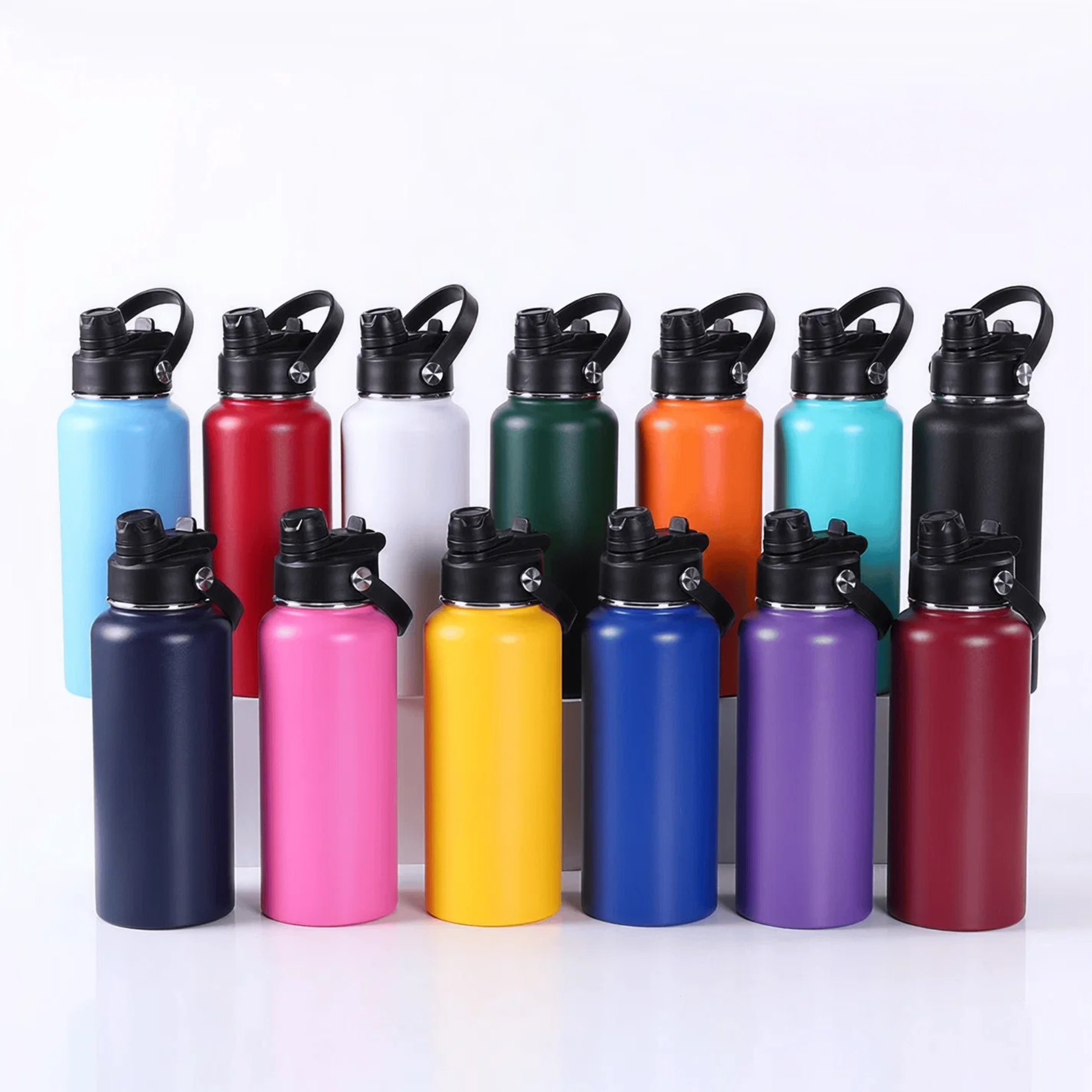 A set of twelve insulated stainless steel water bottles with flip-top lids, arranged in two rows on a white background. The bottles come in a variety of colors including light blue, dark blue, pink, yellow, green, orange, purple, red, and white.