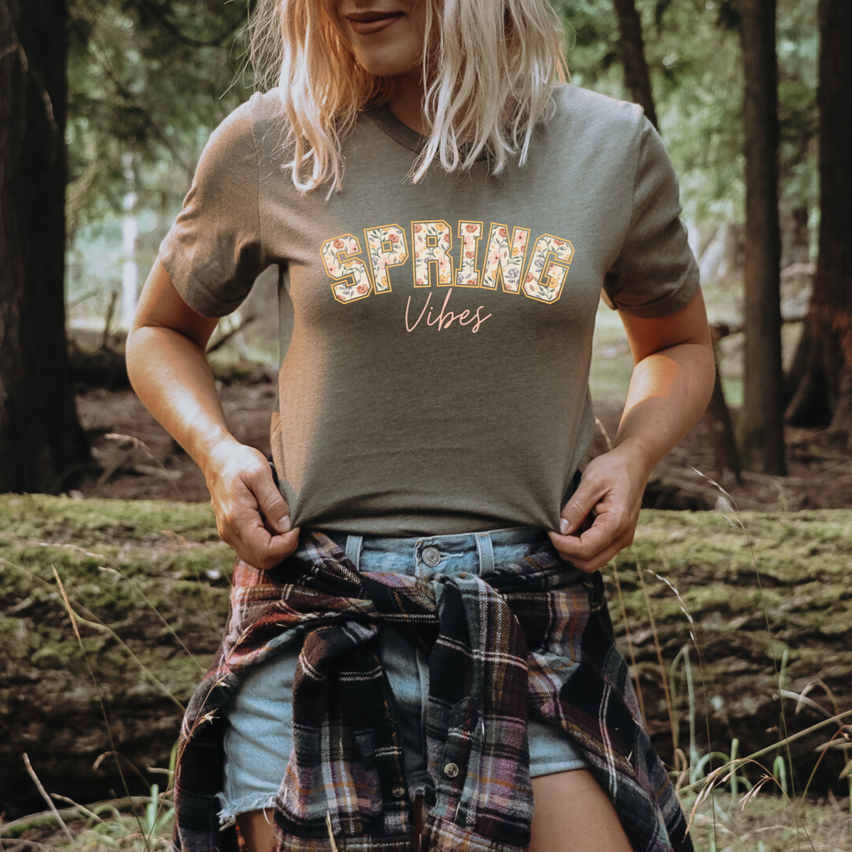 Winks Design Studio Spring Vibes floral tee featuring colorful spring flower patterns on soft fabric shirt.