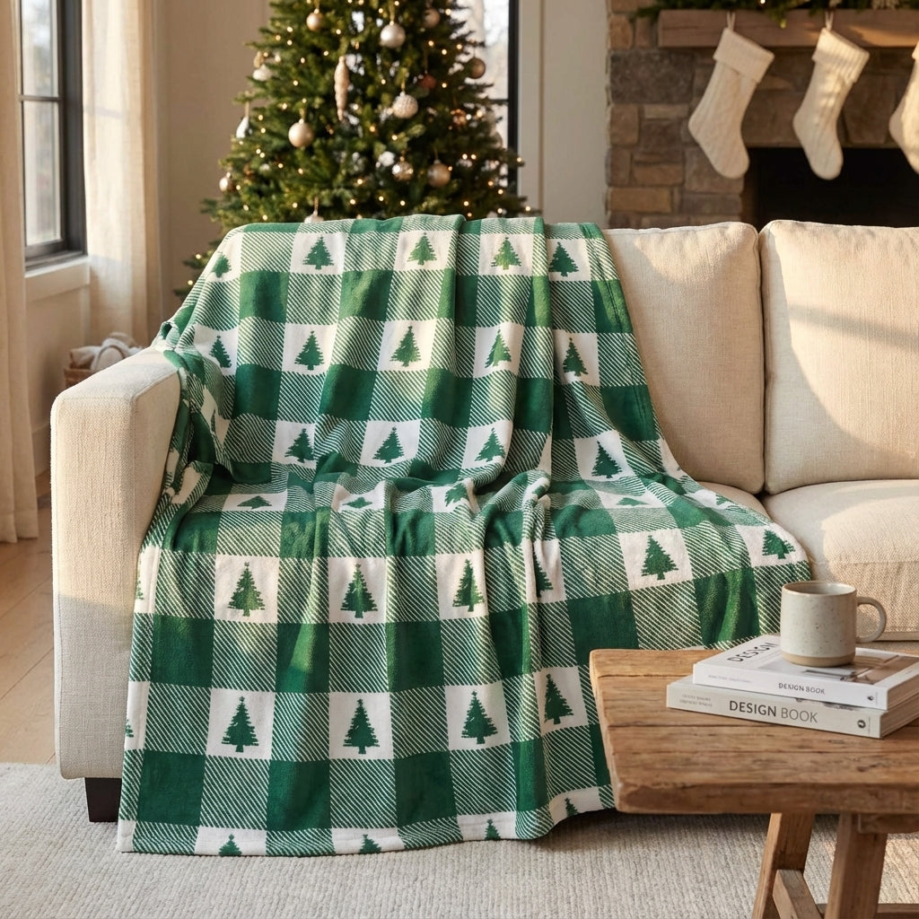 Green and white checkered blanket with tree pattern draped over a beige sofa in a cozy living room.