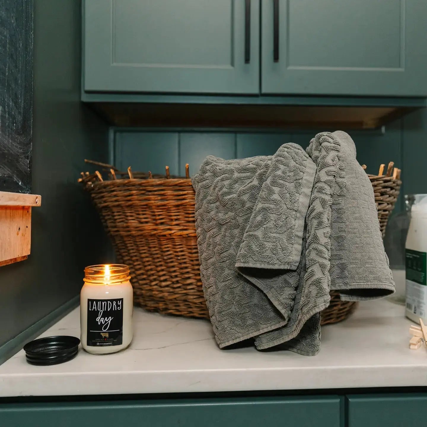 Winks Design Studio Milkhouse Candle Laundry Day in a 13 oz mason jar with a rustic label and white wax, cozy and inviting.