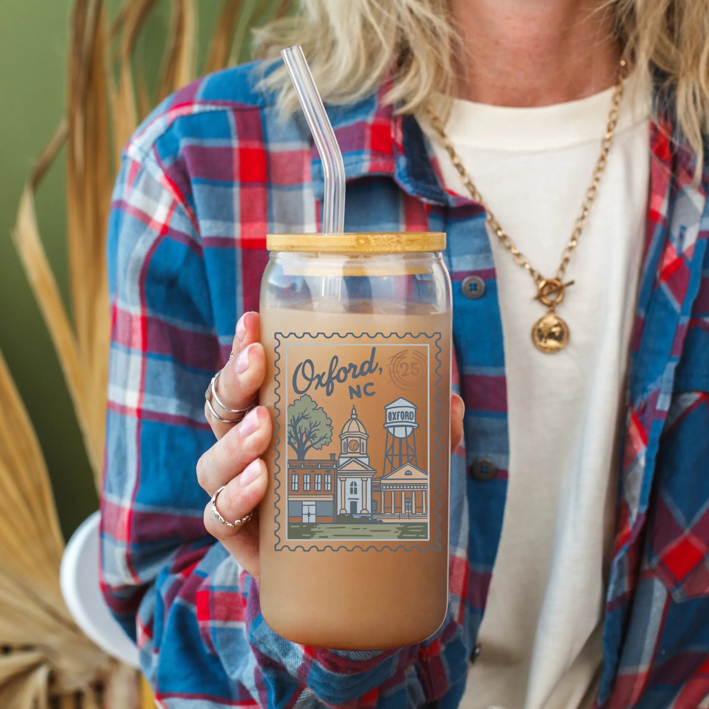 Clear glass beer can from Winks Design Studio, LLC, with Oxford NC Postage Stamp design, 20oz capacity, and sleek shape.