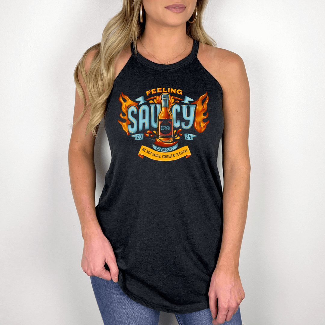 Woman wearing NC Hot Sauce Contest & Festival "Feeling Saucy" halter tank top in black with fiery design.