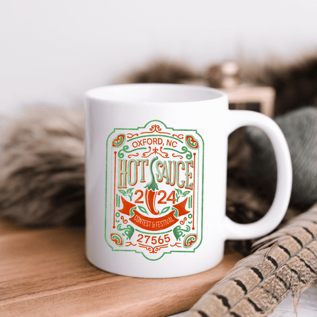 NC Hot Sauce Contest & Festival 2024 ceramic mug with vintage label design, perfect for hot beverages and festival spirit.