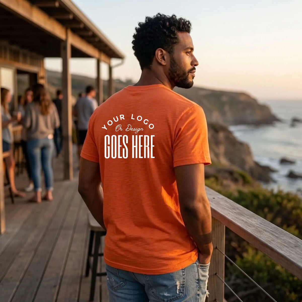 Back view of an orange custom t-shirt with a large white "Your Logo or Design Goes Here" back placeholder print