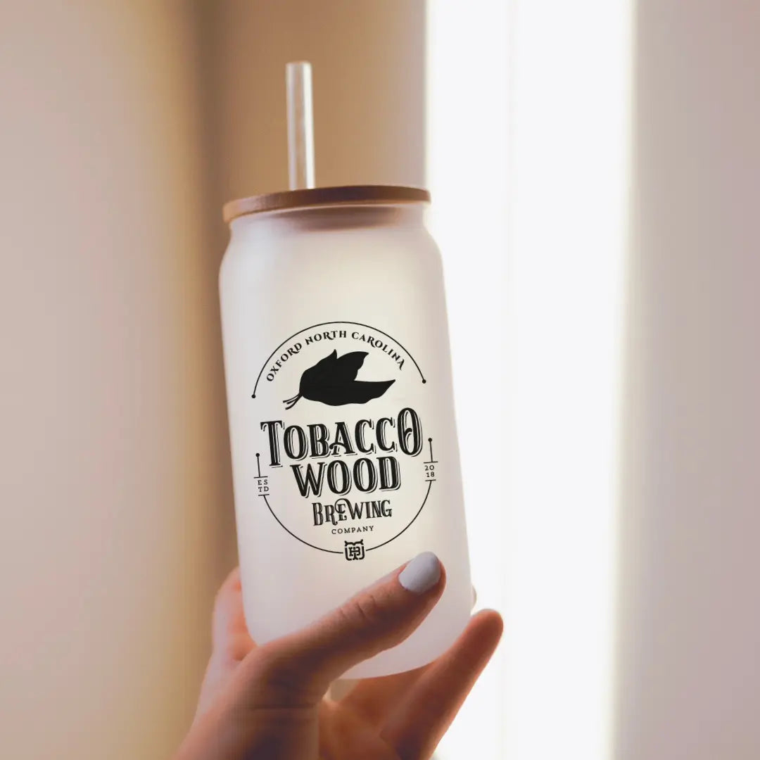 Winks Design Studio Tobacco Wood Brewing 16oz glass can for drinks, featuring clear glass with tobacco wood design accents.