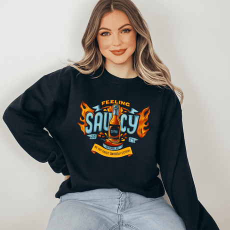 Woman wearing "Feeling Saucy" crewneck sweatshirt for 2024 NC Hot Sauce Contest & Festival