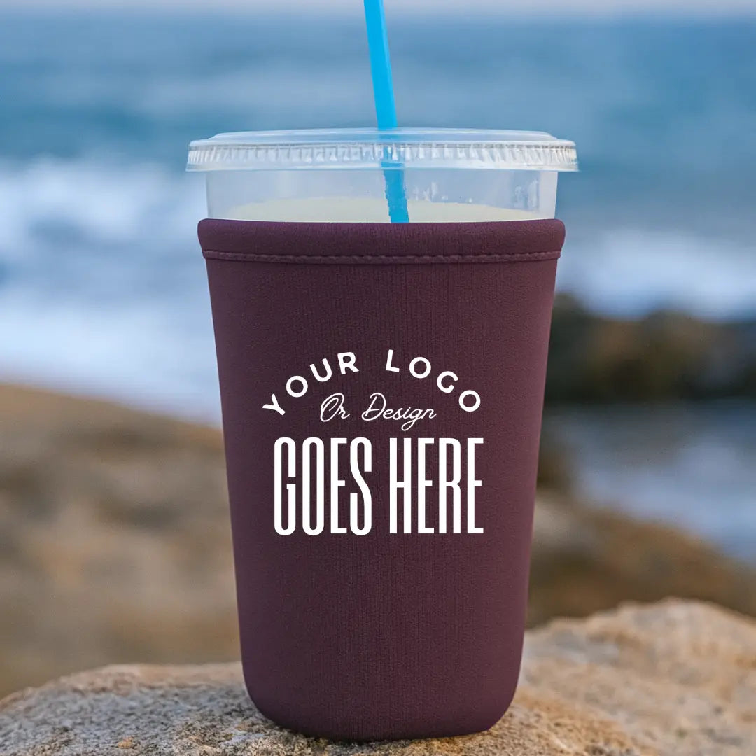 Custom neoprene cup sleeve by Winks Design Studio, LLC, showing a colorful, insulated sleeve fitting around a hot beverage cup.