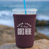 Custom neoprene cup sleeve by Winks Design Studio, LLC, showing a colorful, insulated sleeve fitting around a hot beverage cup.