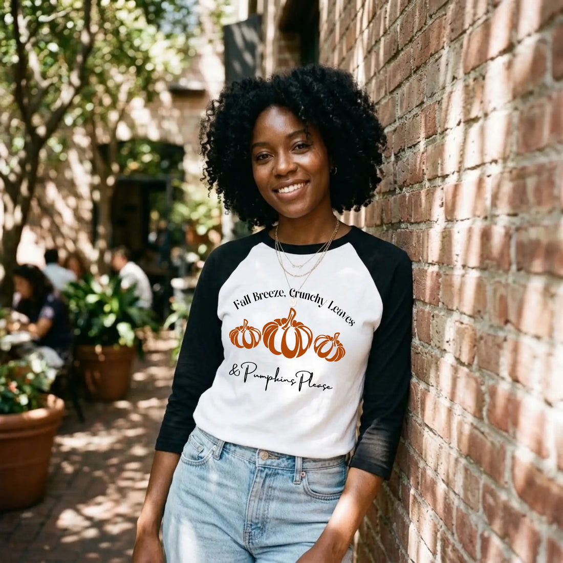 White and black raglan tee with a "Fall Breeze, Crunchy Leaves &amp; Pumpkins Please" graphic and three orange pumpkins