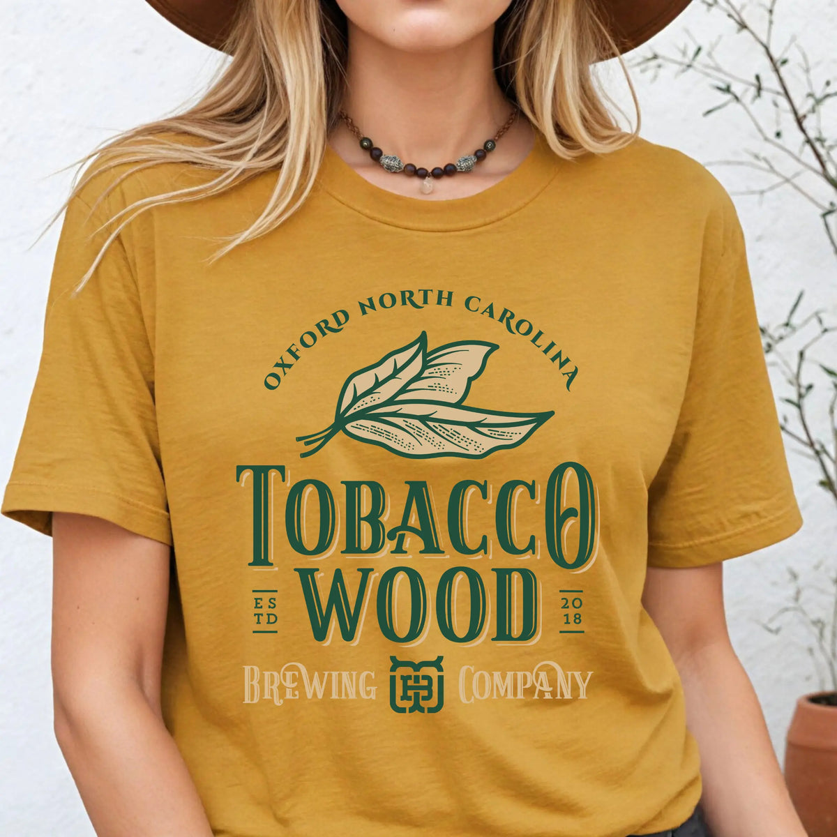Winks Design Studio Tobacco Wood Brewing short sleeve T-shirt featuring a graphic print on a casual cotton shirt.