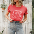 Person wearing a red t-shirt with 'North Carolina' design against a wooden fence background