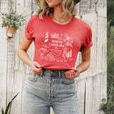 Person wearing a red t-shirt with 'North Carolina' design against a wooden fence background