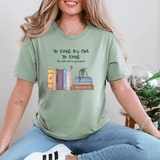 Woman wearing green "To Read Or Not To Read" T-shirt with whimsical book stack design, perfect for book lovers.