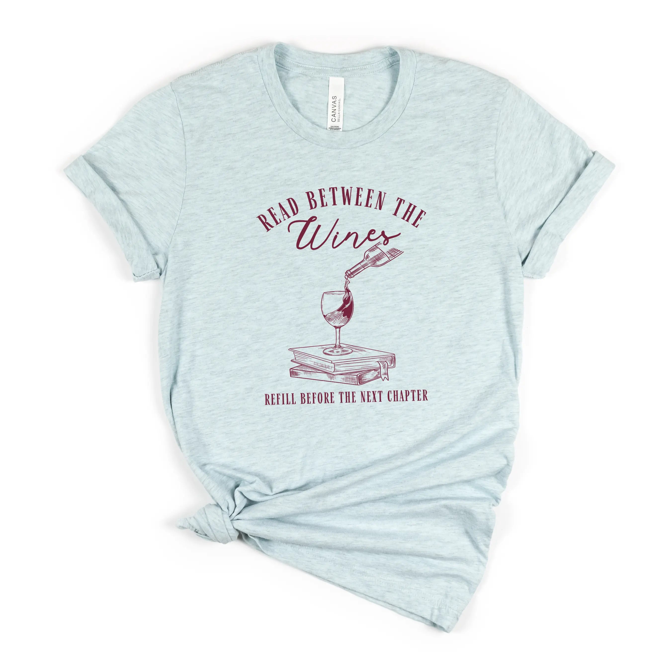 Read Between the Wines T-shirt by Winks Design Studio, LLC featuring a casual cotton tee with wine-themed graphic design.