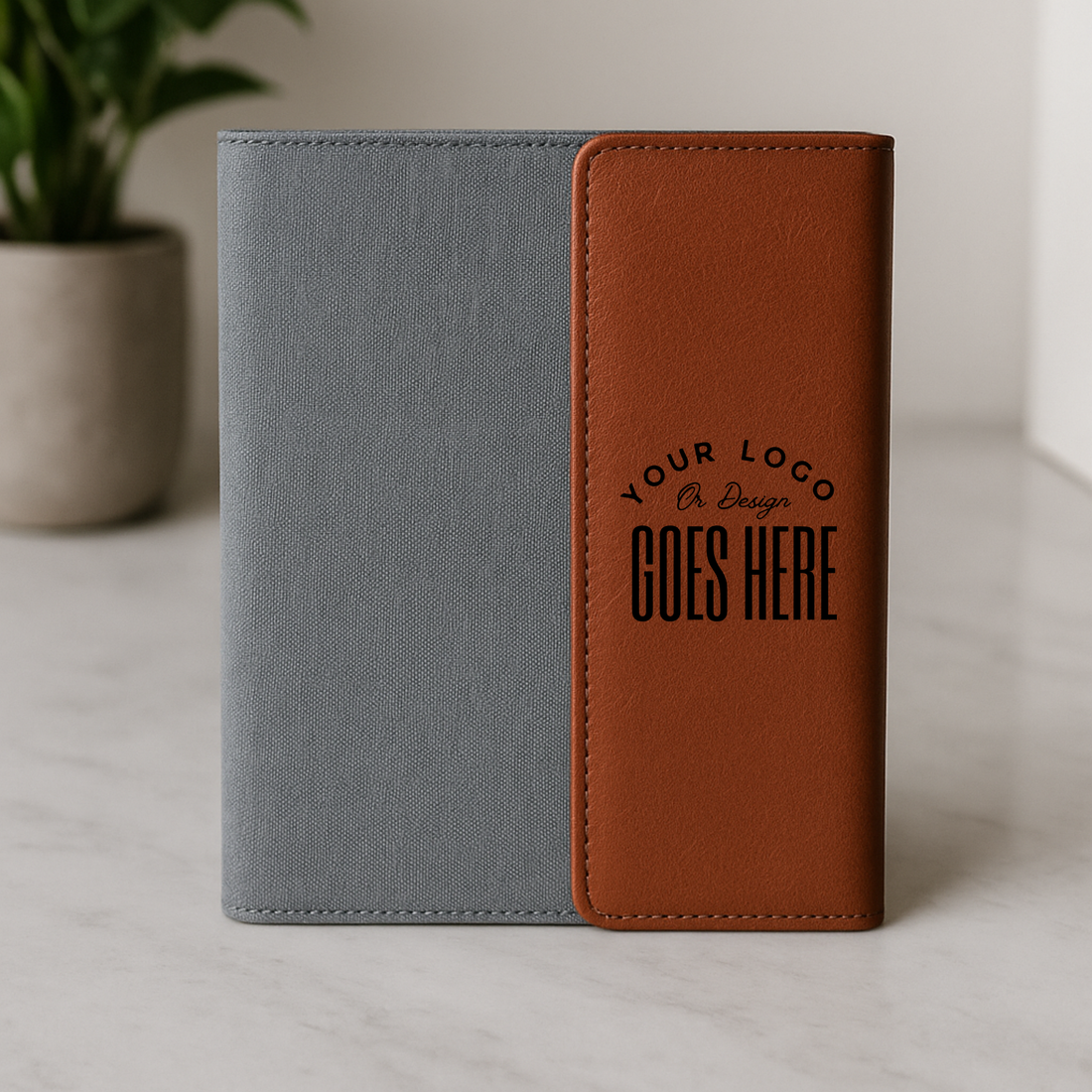 Gray and brown notebook with customizable logo area on a light surface.