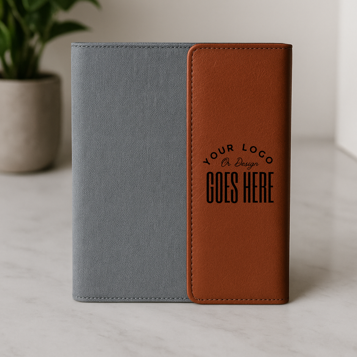 Gray and brown notebook with customizable logo area on a light surface.