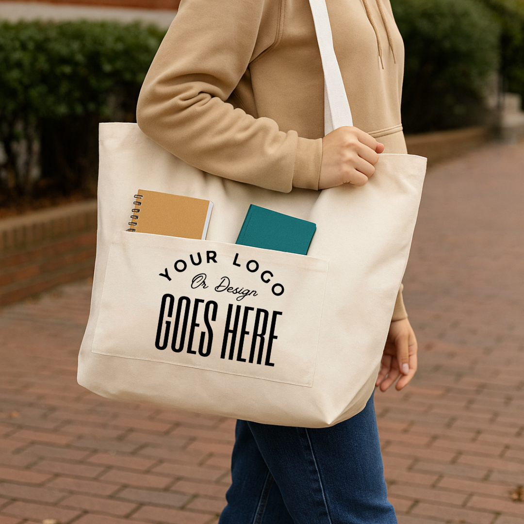 Beige tote bag with customizable text held by a person on a brick path.