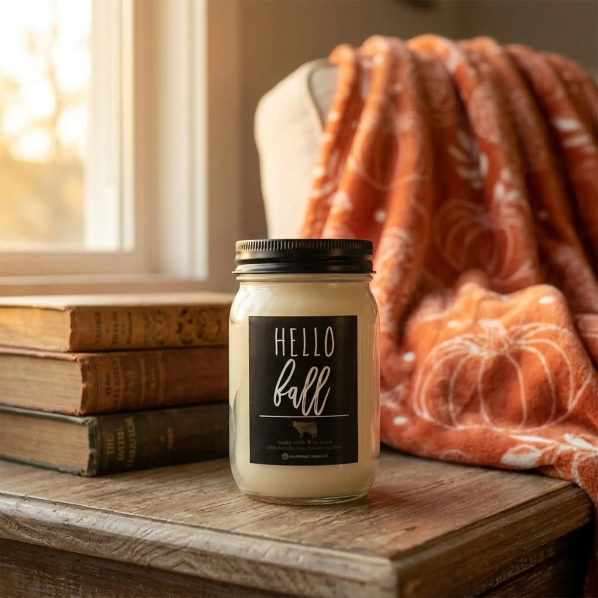 A glass jar candle with a black lid and a black label reading &