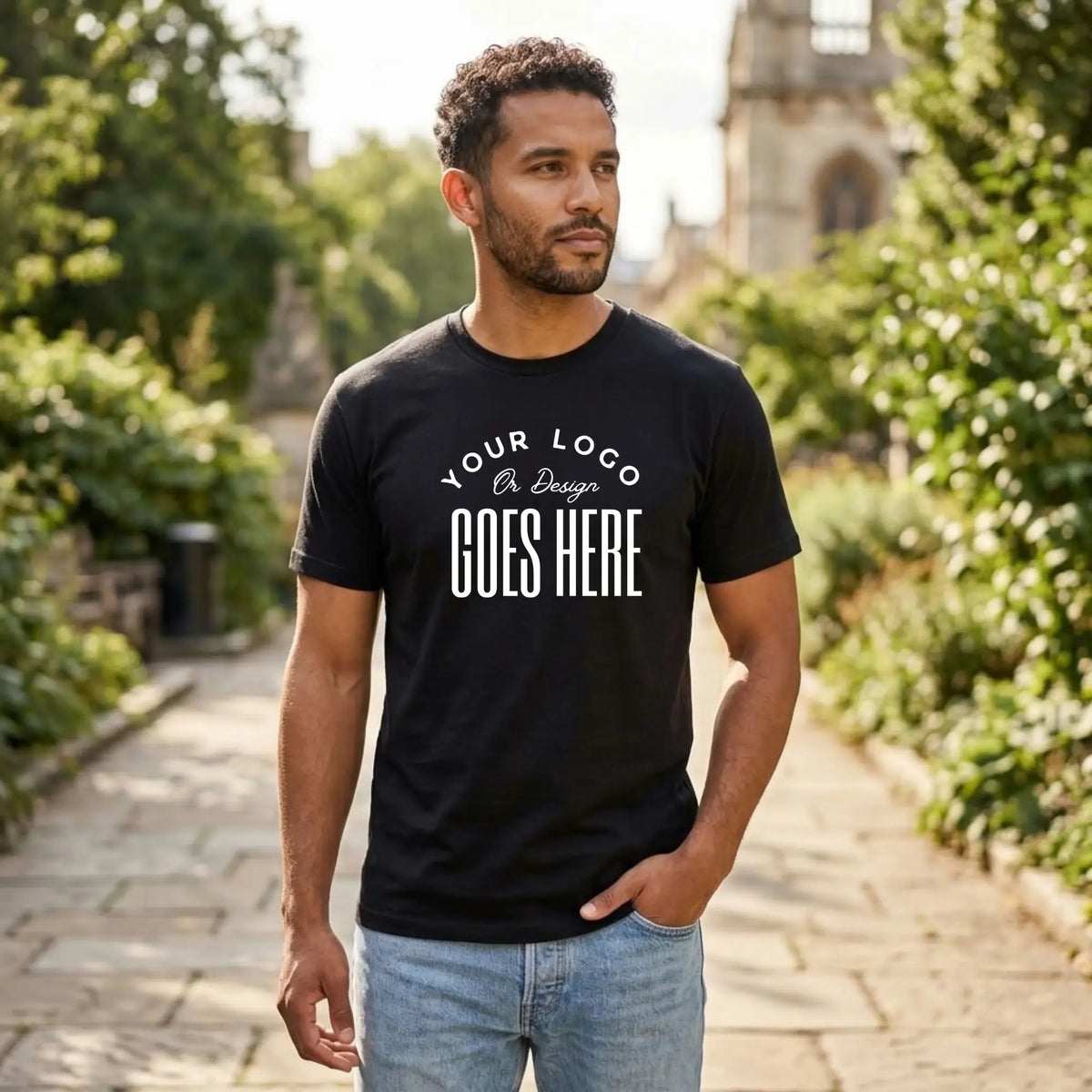 Black custom t-shirt with a large white "Your Logo or Design Goes Here" center chest placeholder print
