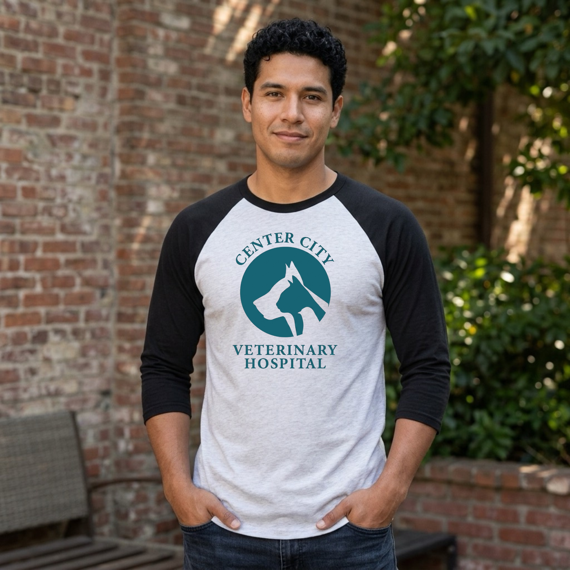 Winks Design Studio Center City Vet raglan baseball T-shirt with navy and white sleeves and a centered graphic design.