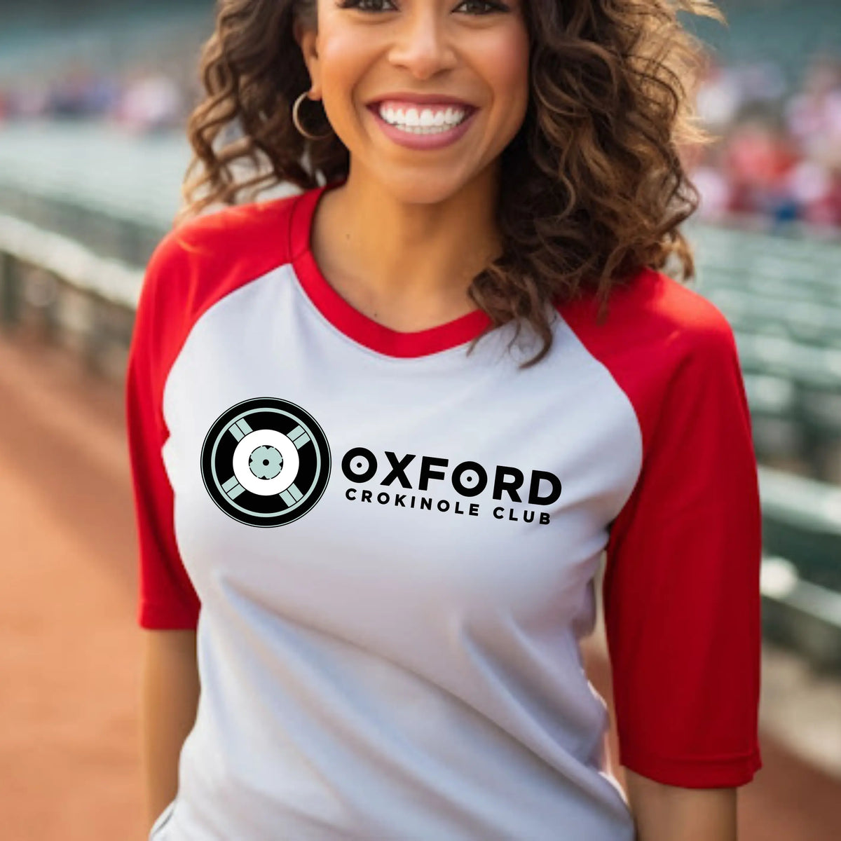 Oxford Crokinole Club raglan T-shirt by Winks Design Studio, LLC featuring a casual fit with a Crokinole game graphic on the front.