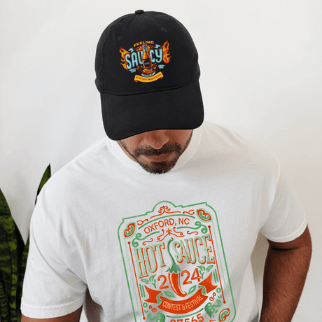 Man wearing "Feeling Saucy" NC Hot Sauce Contest & Festival Twill Hat and matching 2024 festival t-shirt.