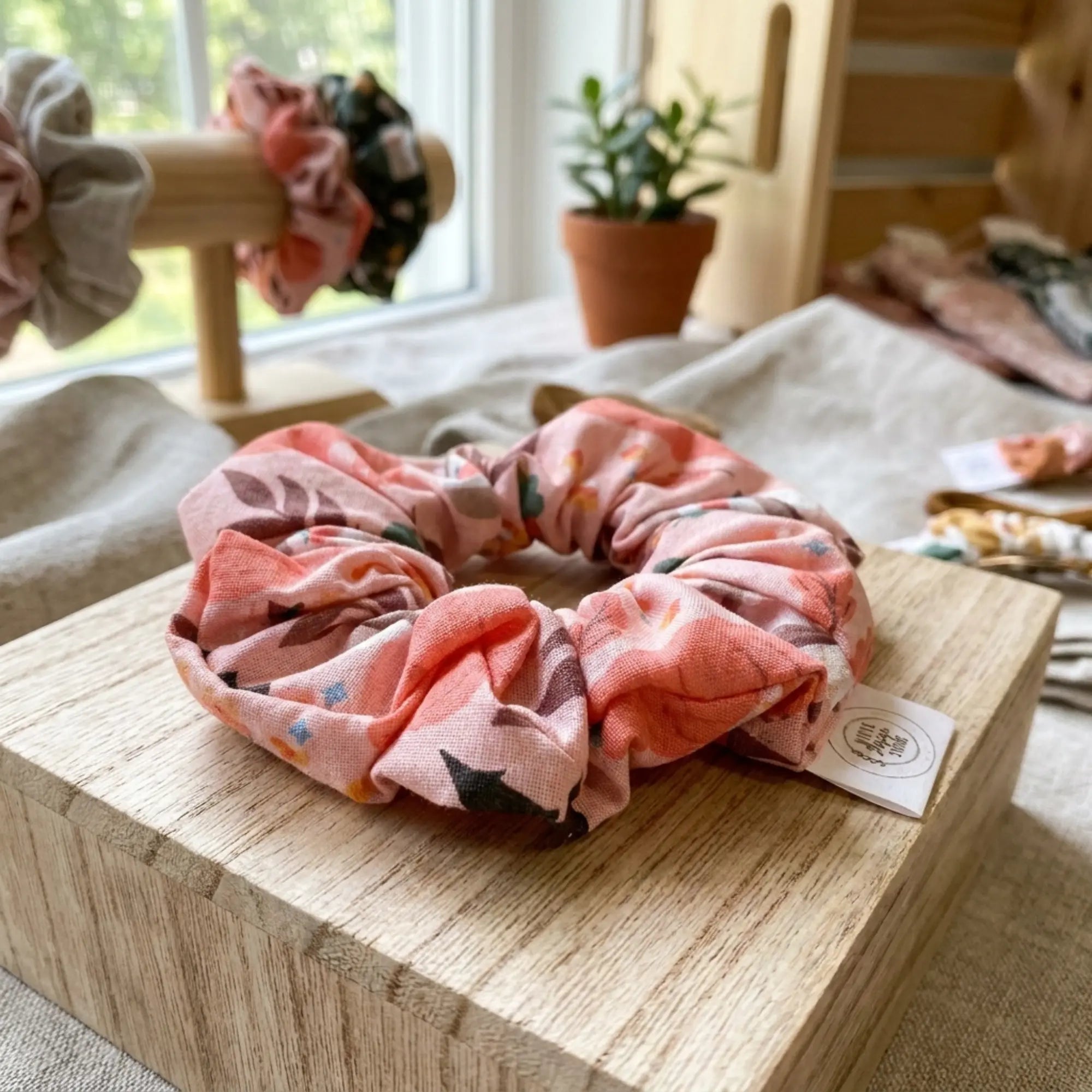 Pumpkin Patch fall-themed scrunchie by Winks Design Studio, LLC featuring cozy autumn-inspired fabric and vibrant fall colors.