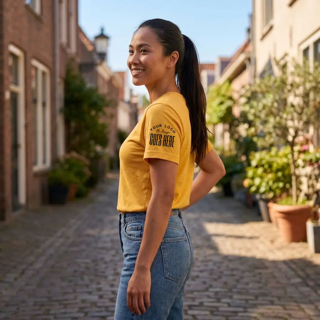 Side view of a mustard yellow custom t-shirt with a black "Your Logo or Design Goes Here" sleeve placeholder print