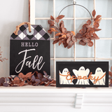 Halloween-themed spooky sign with ghosts and "Hello Fall" décor on a mantel, perfect for autumn DIY craft workshops.