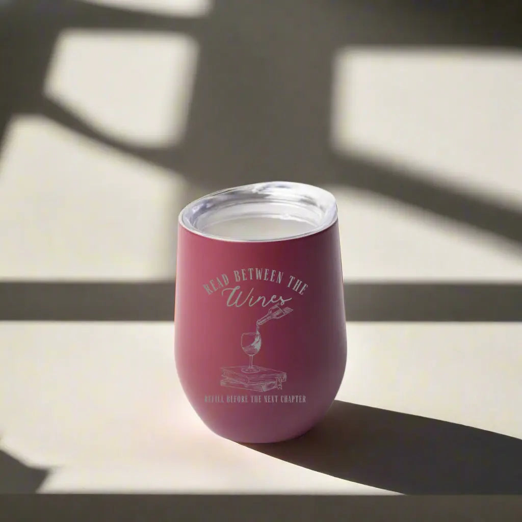 Stemless wine tumbler with "Read Between the Wines" design by Winks Design Studio, LLC, 12oz capacity.