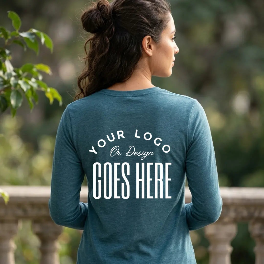 Back view of a heather deep teal custom long sleeve t-shirt with a large white "Your Logo or Design Goes Here" back placeholder print