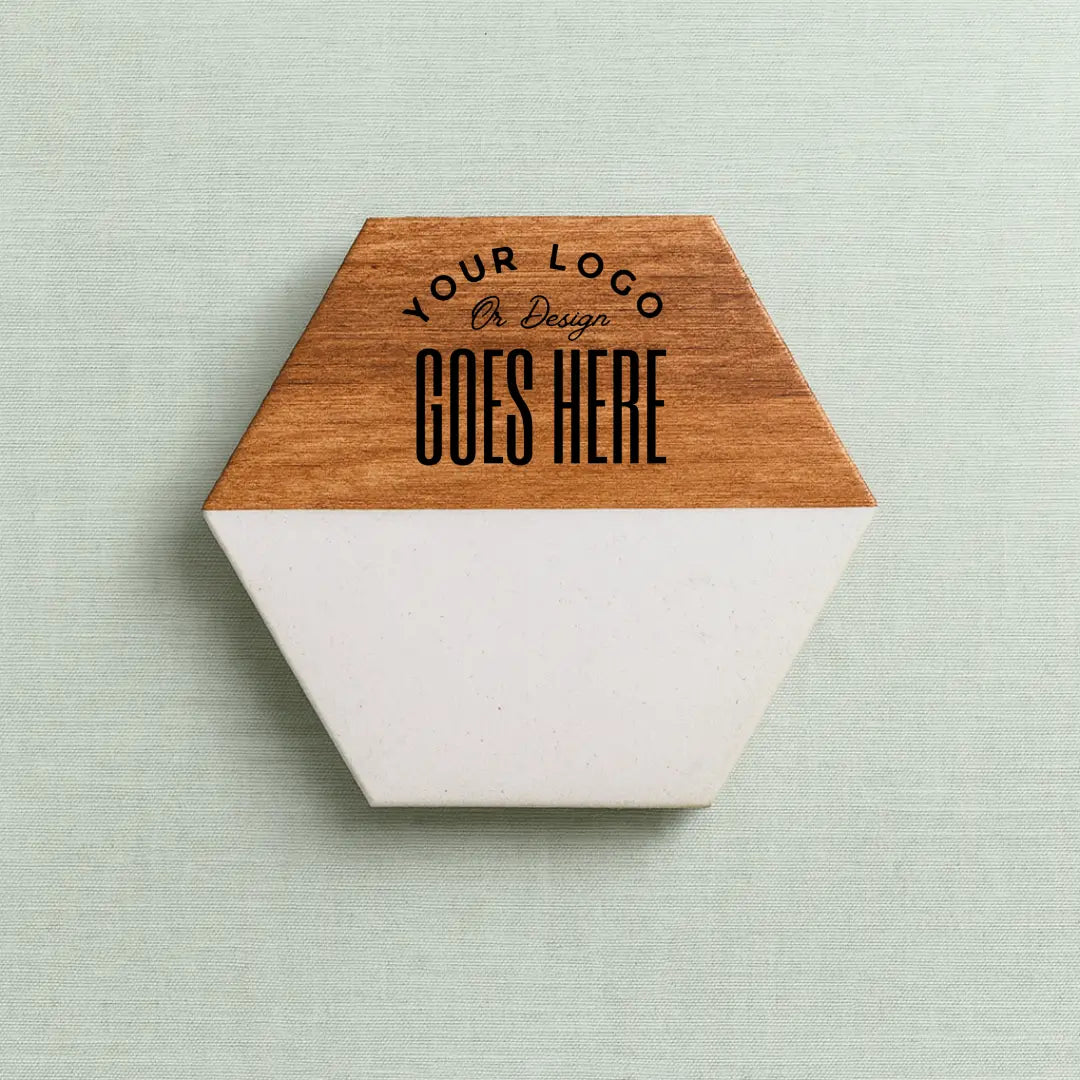 Set of two custom engraved marble coasters with Winks Design Studio LLC branding, featuring elegant natural stone patterns.