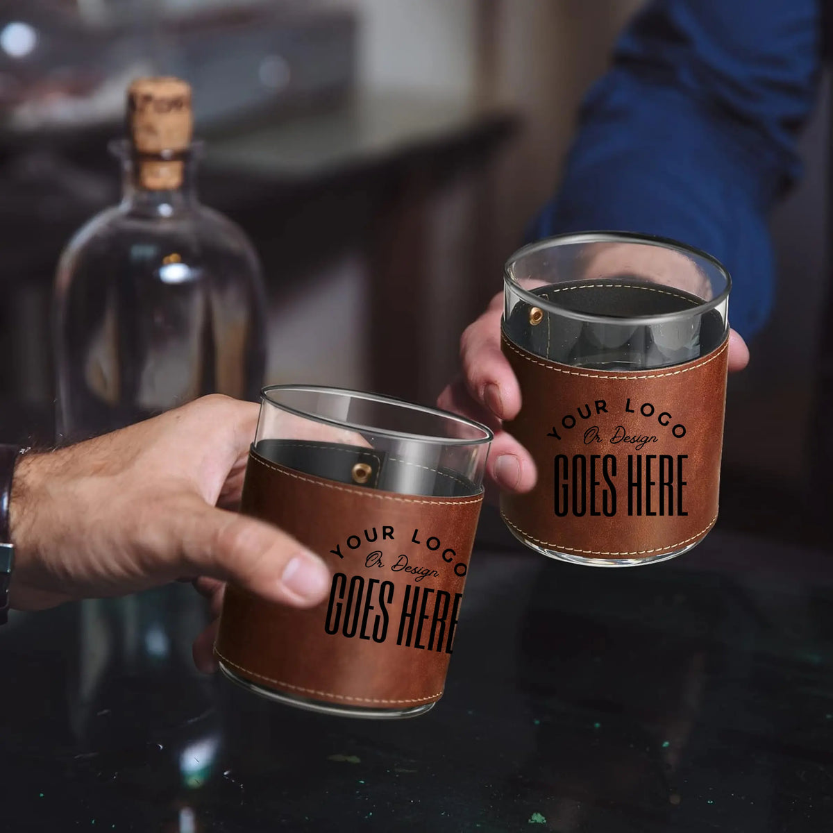 Two custom leather-wrapped rock glasses from Winks Design Studio, LLC, featuring a stylish and unique design for drinks.