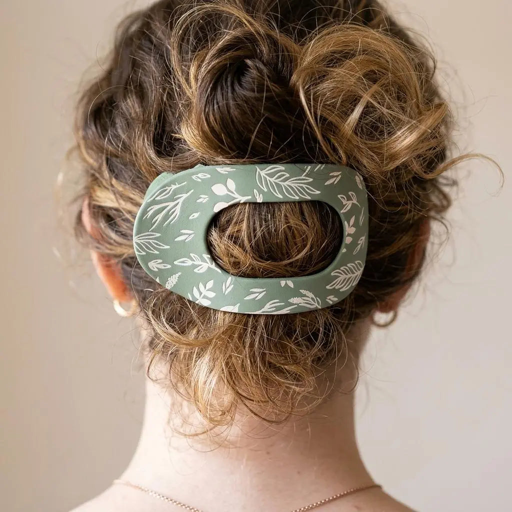 Winks Design Studio LLC sage and stem claw clip holding hair, featuring a natural, decorative design with sage green and floral accents.