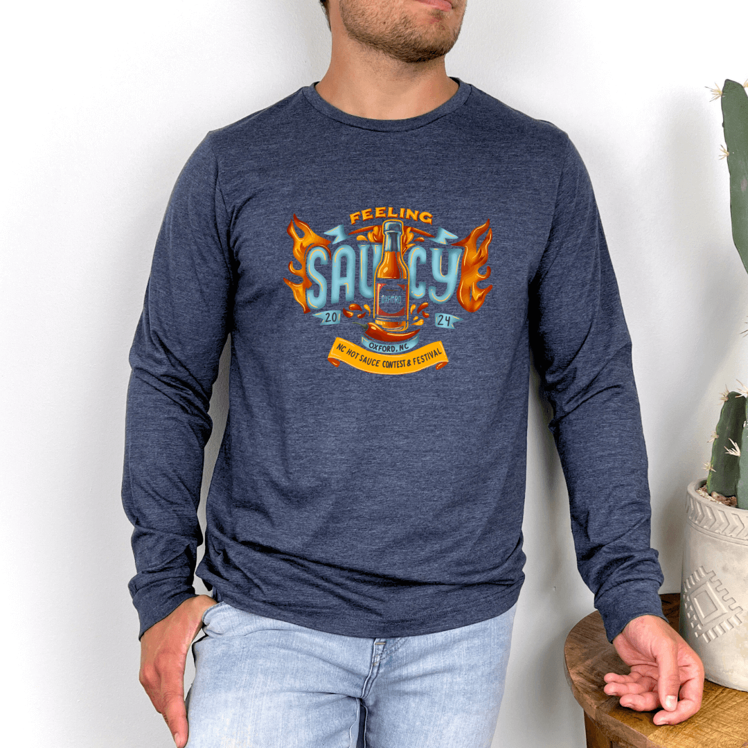 "Man wearing NC Hot Sauce Contest & Festival long sleeve shirt with 'Feeling Saucy' design in blue"