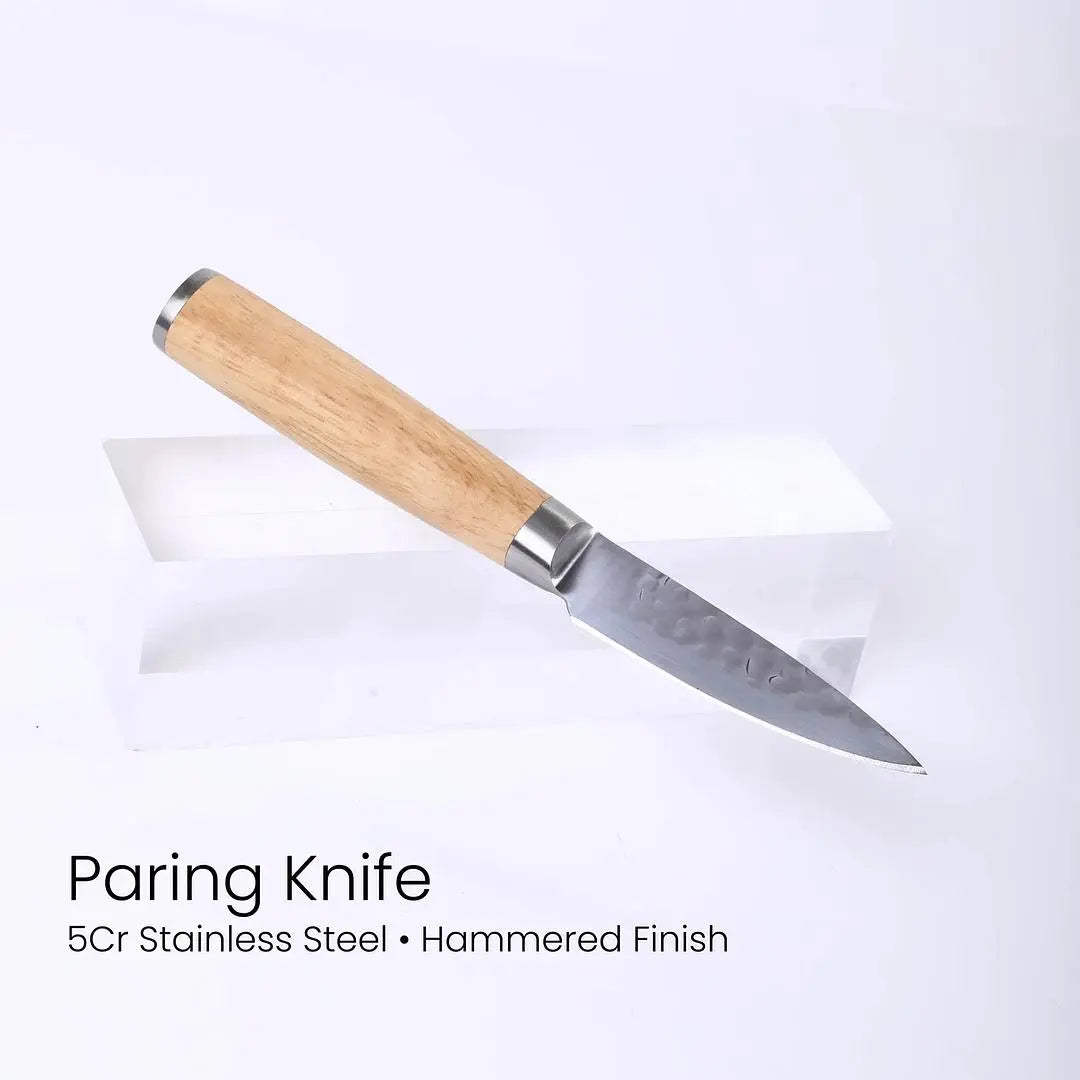 Six custom engraved chef knives with black handles arranged in a magnetic rubberwood block for kitchen and dining use.
