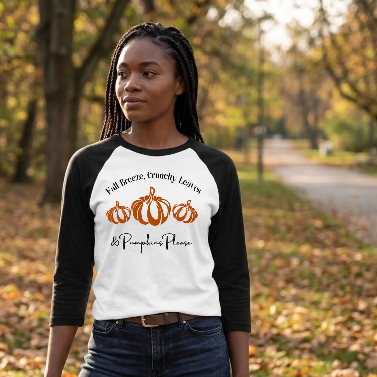 Woman in a white and black "Fall Breeze, Crunchy Leaves &amp; Pumpkins Please" raglan tee on a wooded autumn path