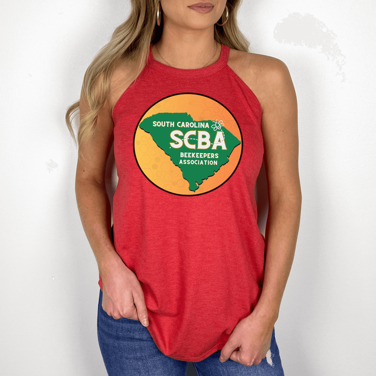 Woman wearing SCBA Halter Tank in red, featuring South Carolina Beekeepers Association logo, showcasing comfort and style with tri-blend fabric.