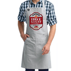 Person wearing a gray apron with a 'Hot Stuff' design on a white background