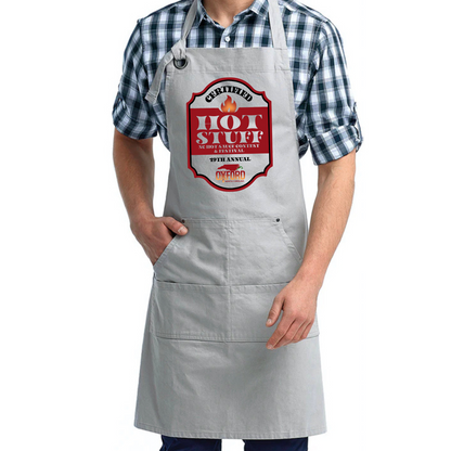 Person wearing a gray apron with a &