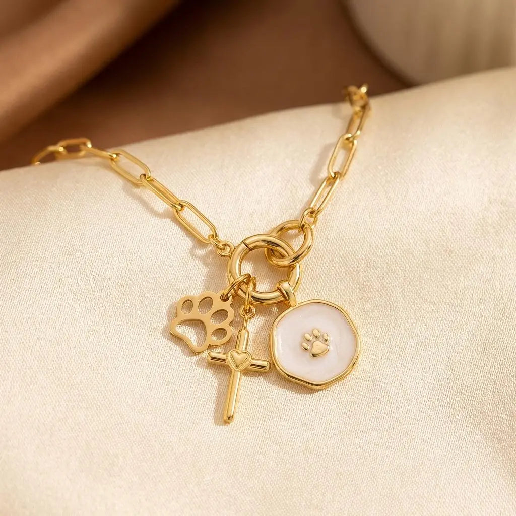 18K gold paw print charm by Winks Design Studio, LLC featuring detailed paw print design on a small, elegant jewelry charm