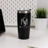A black thermos cup with the MS Associates logo on it, placed on a white desk next to a laptop and a potted plant.