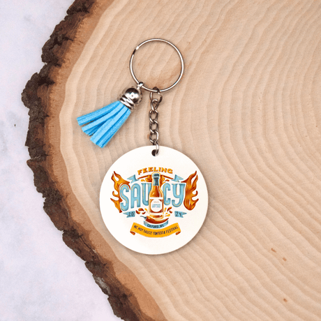 "Feeling Saucy" Keychain from the 2024 NC Hot Sauce Contest & Festival, stylish accessory for hot sauce enthusiasts and festival-goers