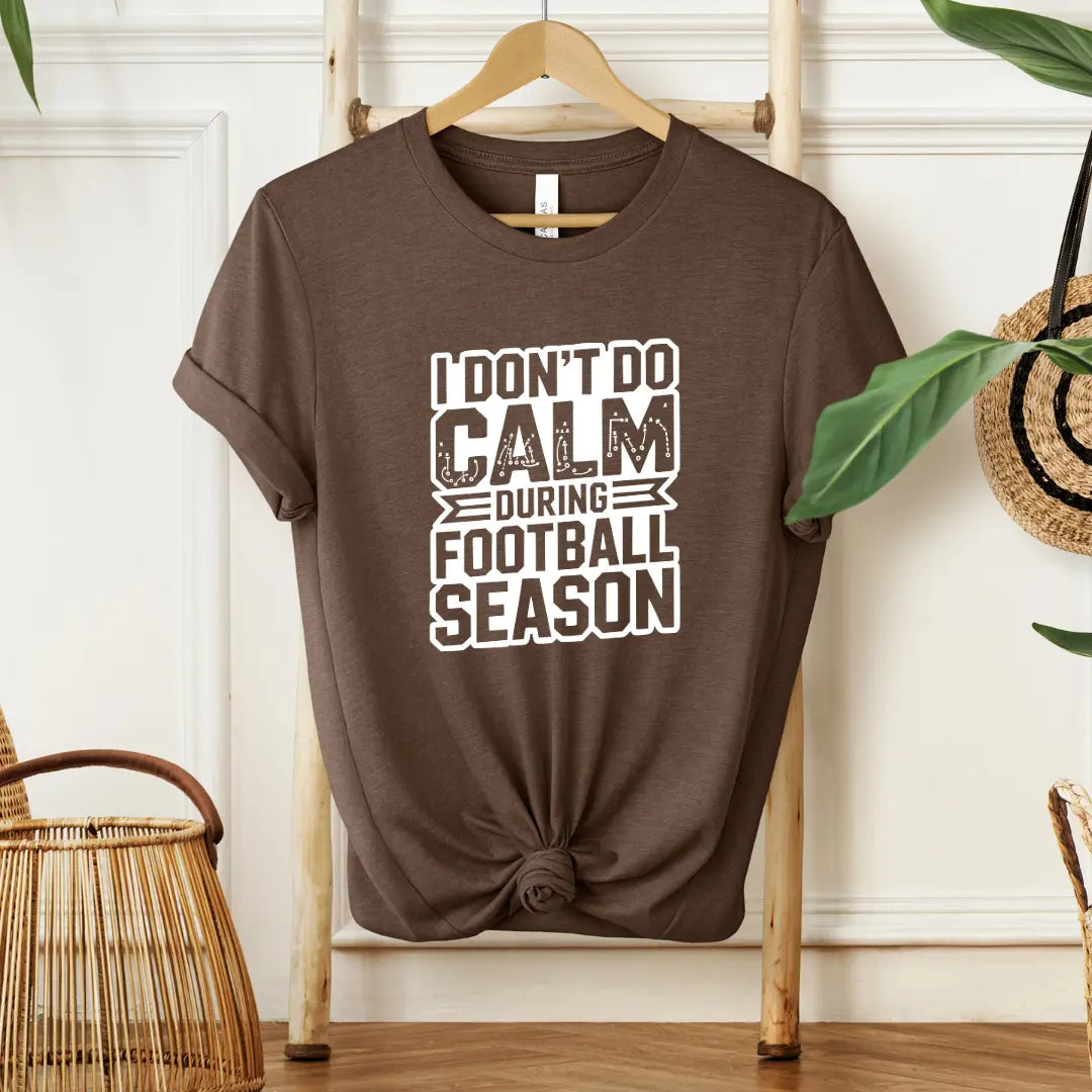 Winks Design Studio I Don’t Do Calm football T-shirt featuring bold text and casual fit, front view on plain background.