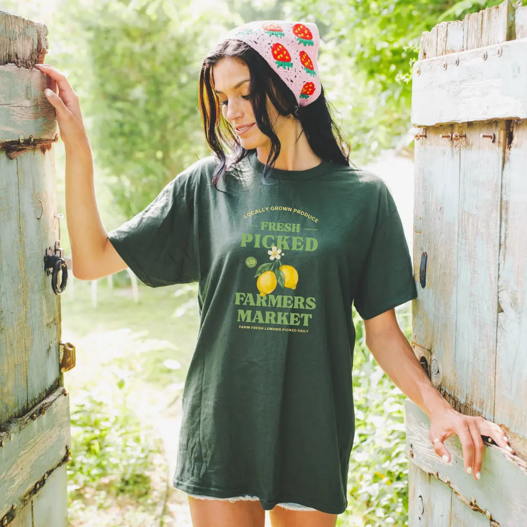 Winks Design Studio LLC Farmers Market fresh picked lemon T-shirt with vibrant lemon graphic on white cotton fabric.